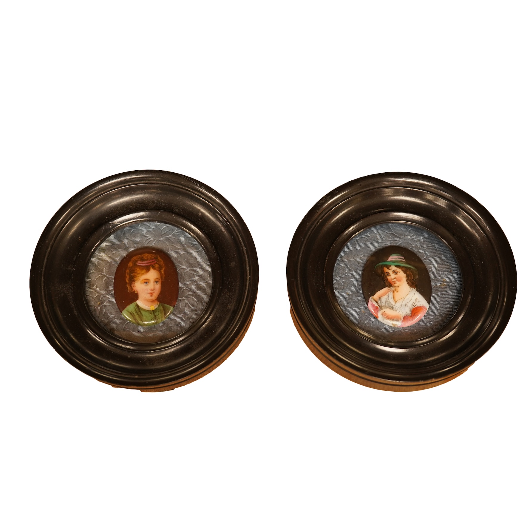 A pair of circular framed oval miniatures on porcelain plaques. Plaques 3.5cm high